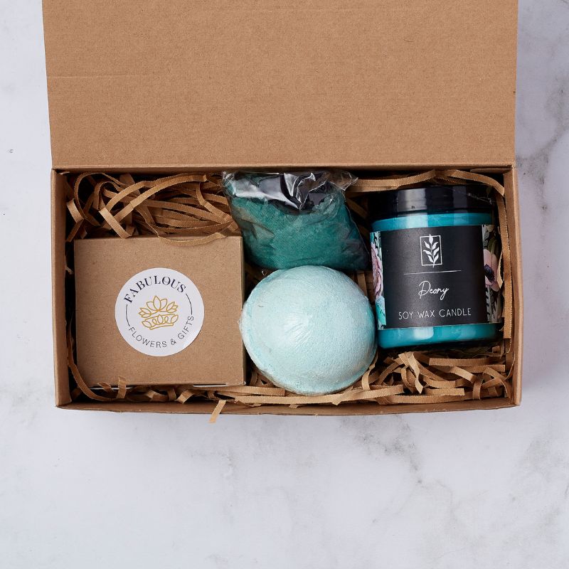 Gift box containing a Fabulous Flowers box, bath bomb, soy wax candle, and bath salts in teal tones.