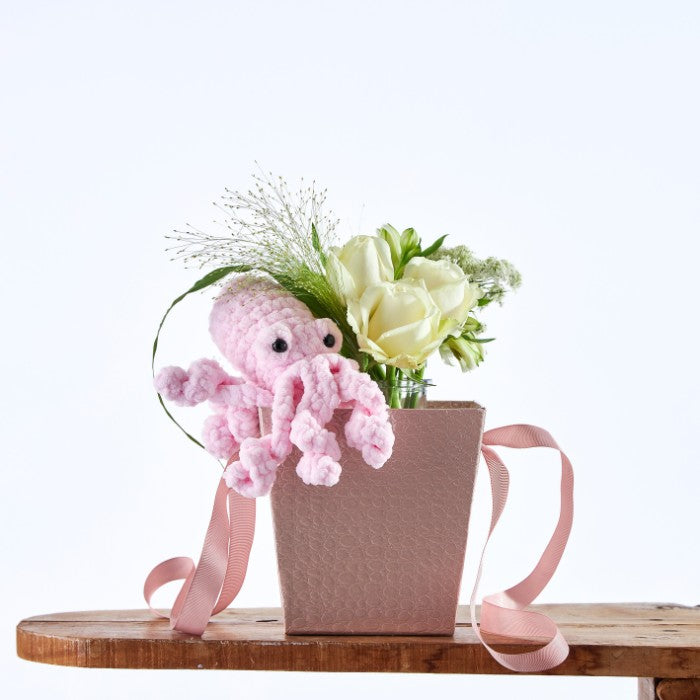 Pink Puddle Octopus Garden: Pink crochet octopus with white roses in a textured grey gift box.