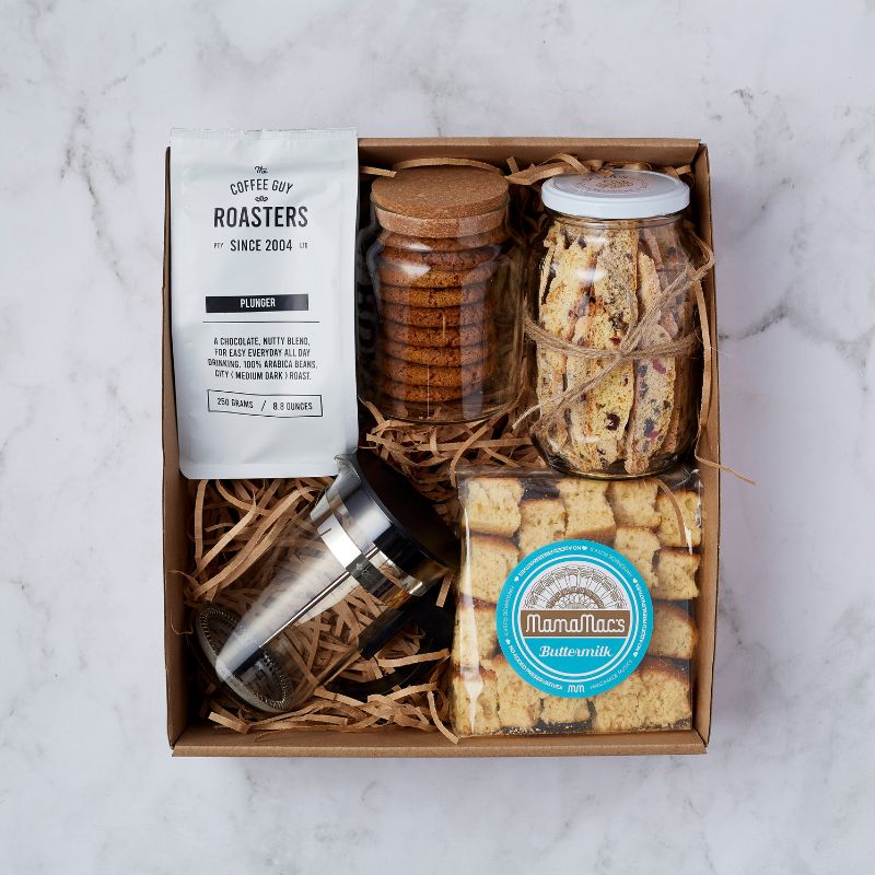 Top view of gift box featuring coffee beans, coffee plunger, cookies, biscotti, and buttermilk rusks