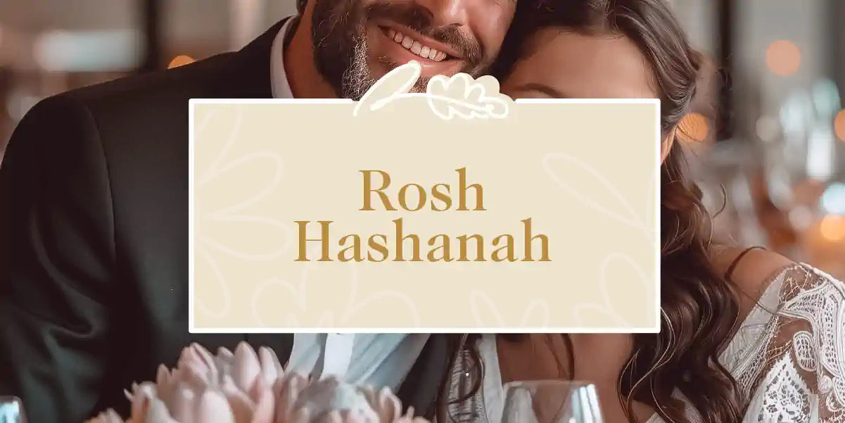 A couple celebrating Rosh Hashanah, smiling and enjoying the occasion with a beautiful floral arrangement. Fabulous Flowers and Gifts - Rosh Hashanah