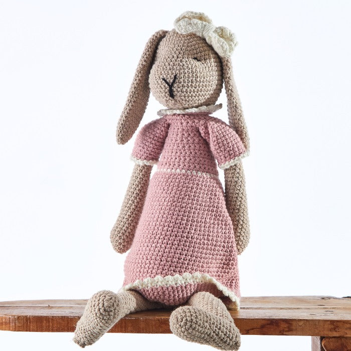 Handcrafted Rosie Rabbit doll dressed in a soft pink gown, perfect for a child's gift or nursery decoration.