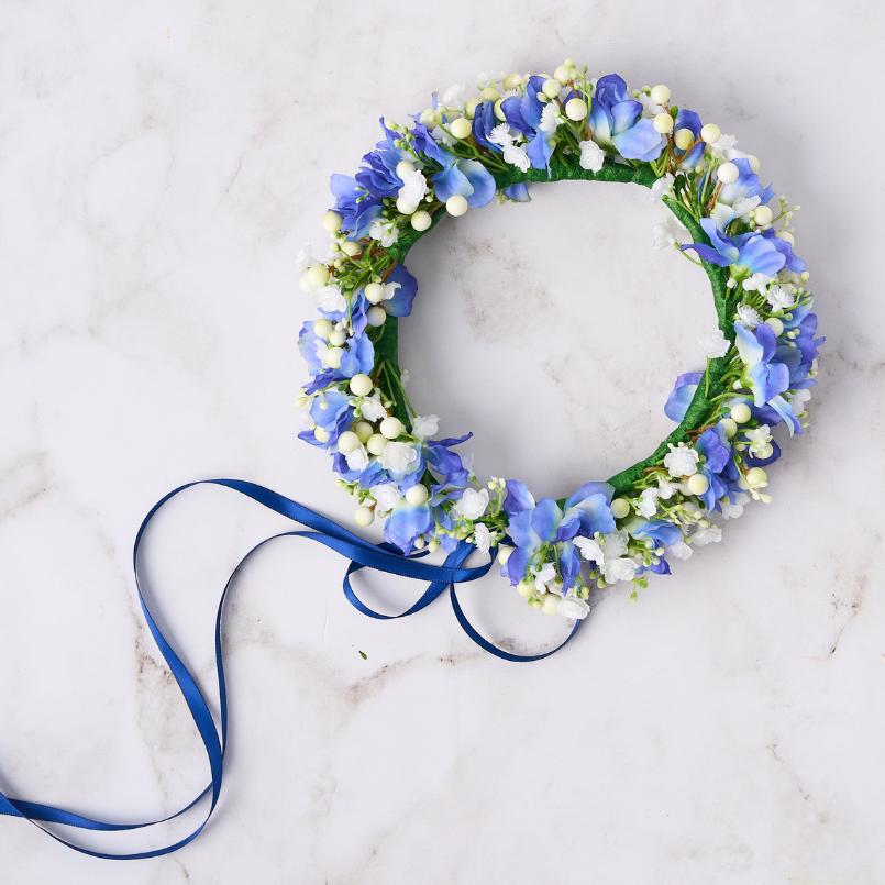 Handmade Sapphire Mist Blue Flower Crown showcasing vibrant blue flowers and greenery with a ribbon detail.