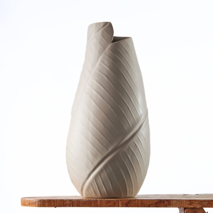 Artistic Serenity Swirl Vase featuring a unique twisted design in a soft gray finish, perfect for contemporary interiors.