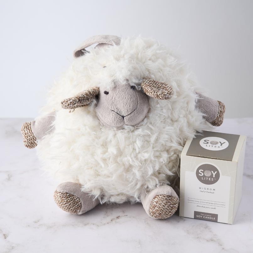 Shleep Time for Baby Girl Gift Set featuring a plush sheep and Soy Lites Wisdom candle, arranged on a white surface.