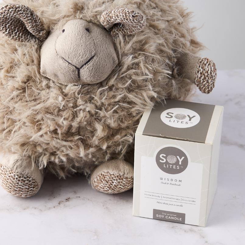 Close-up of Shleep Time with Baby Boy Gift Set featuring a plush brown sheep and Soy Lites Wisdom candle on a white surface.