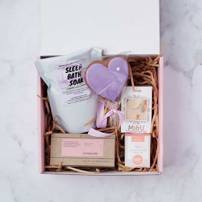 Gift box with sleep bath soak, purple heart cookie, artisan soap, Stoneglow blush rose and peony candle, and Soy Lites harmony candle.