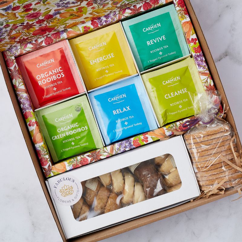 Close-up of the Tea Treat Gift Box showing Carmién rooibos tea sachets and a selection of hand-baked biscuits, perfect for tea lovers and gifting.