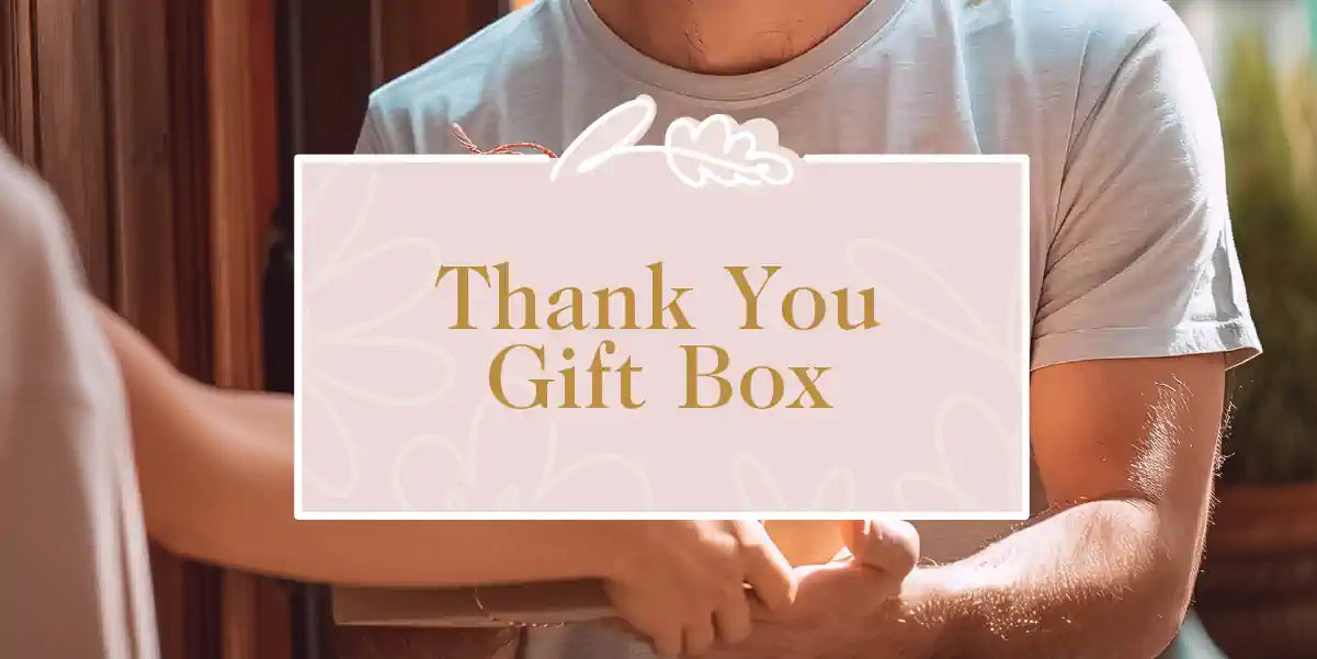 A man handing over an elegantly wrapped gift box. Fabulous Flowers and Gifts - Thank You Gift Box