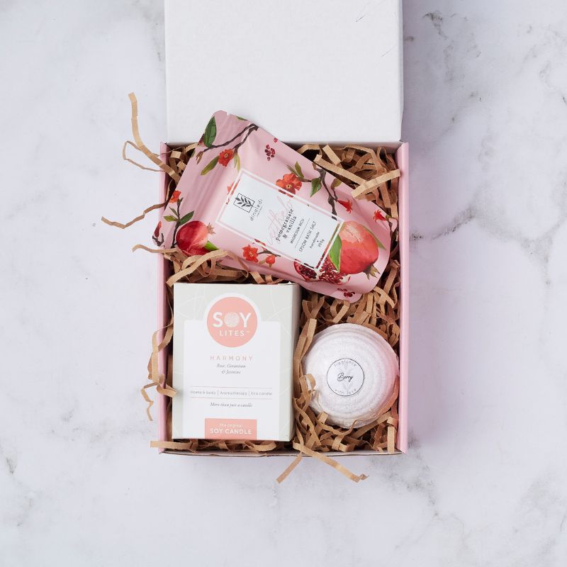 Tickle my Fancy gift box featuring a Soy Lites Harmony candle, bath salts, and bath bomb on shredded paper.