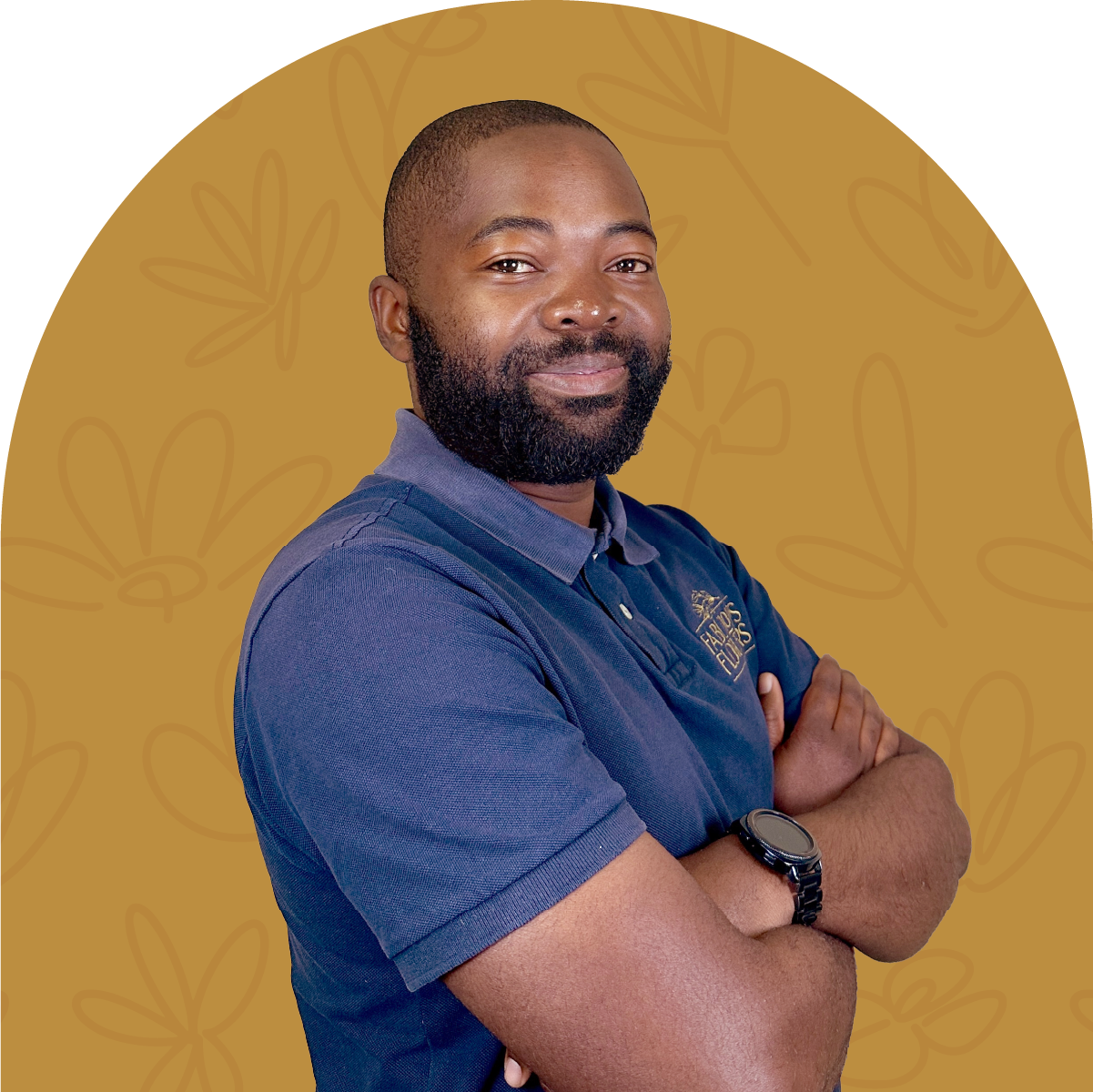 Portrait of Tinashe, a team member at Fabulous Flowers, wearing a navy polo shirt against a mustard yellow background. MEET THE TEAM at Fabulous Flowers and Gifts.