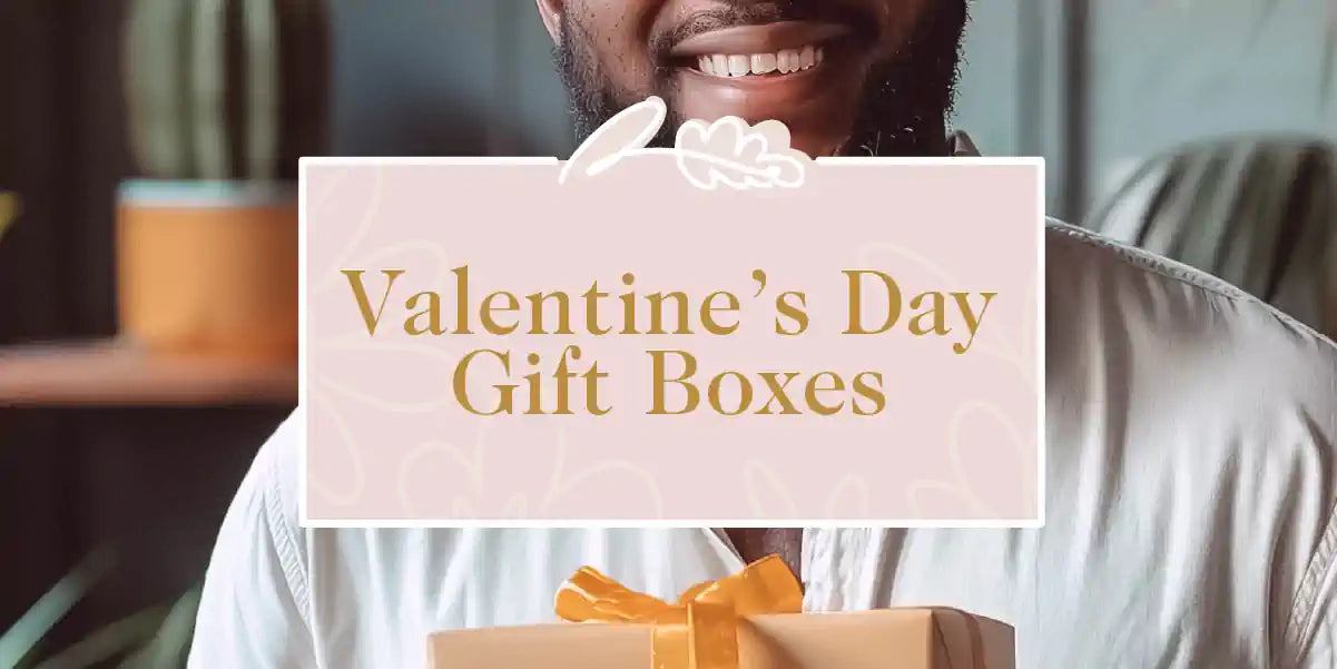 A man holding a beautifully wrapped Valentine's Day gift box with a ribbon. Fabulous Flowers and Gifts - Valentine's Day Gift Boxes