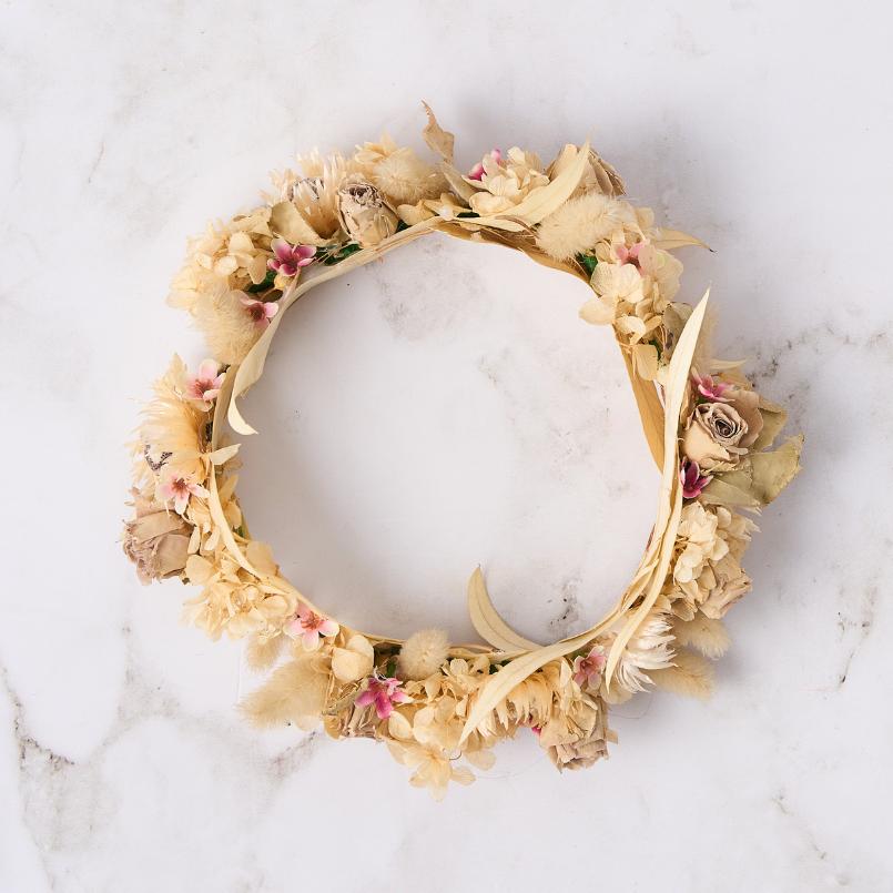 Beige and pink dried flower crown with delicate petals and natural accents.